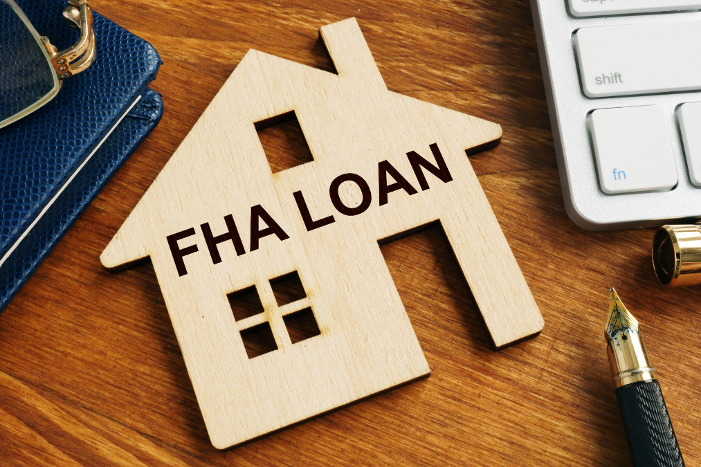 What is an FHA loan? Picture of a wooden house with FHA on the front.
