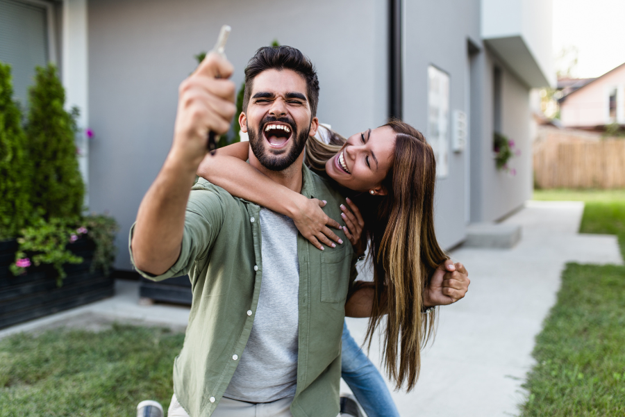 Why It’s Better to Start with a Lender Versus a Realtor - Excited couple who just bought a house