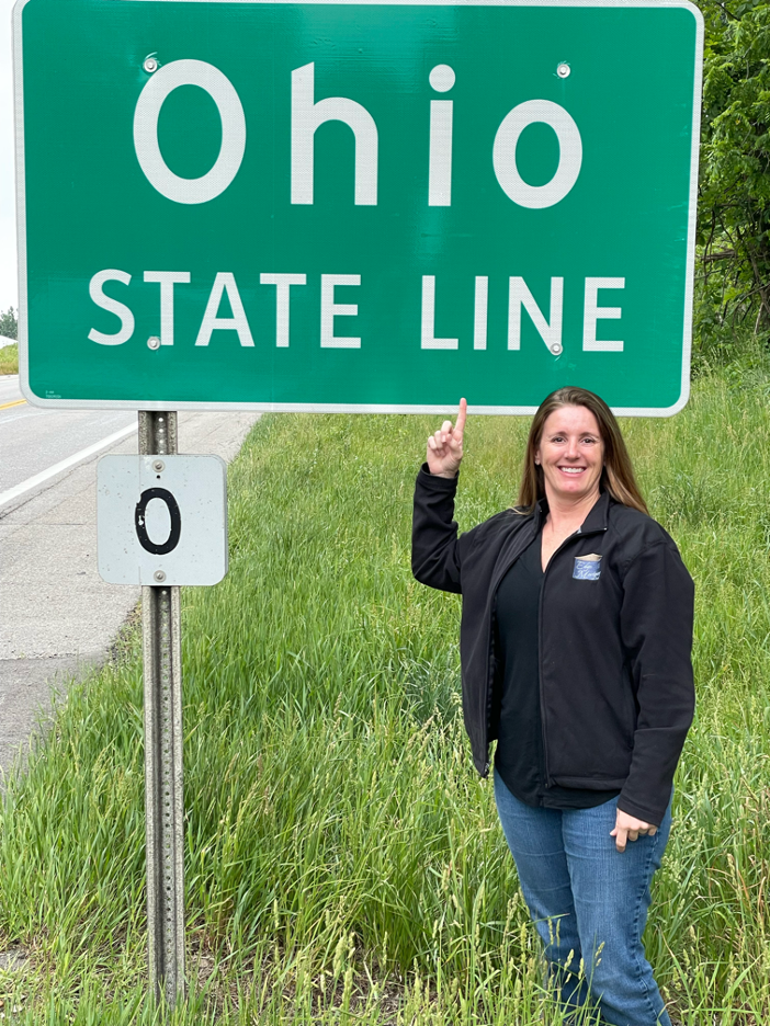 Ohio Mortgage Broker - Keri in front of the Ohio state line sign